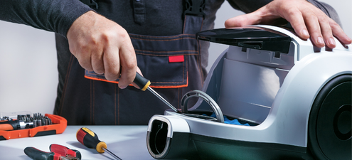 Machine technician repairing equipment